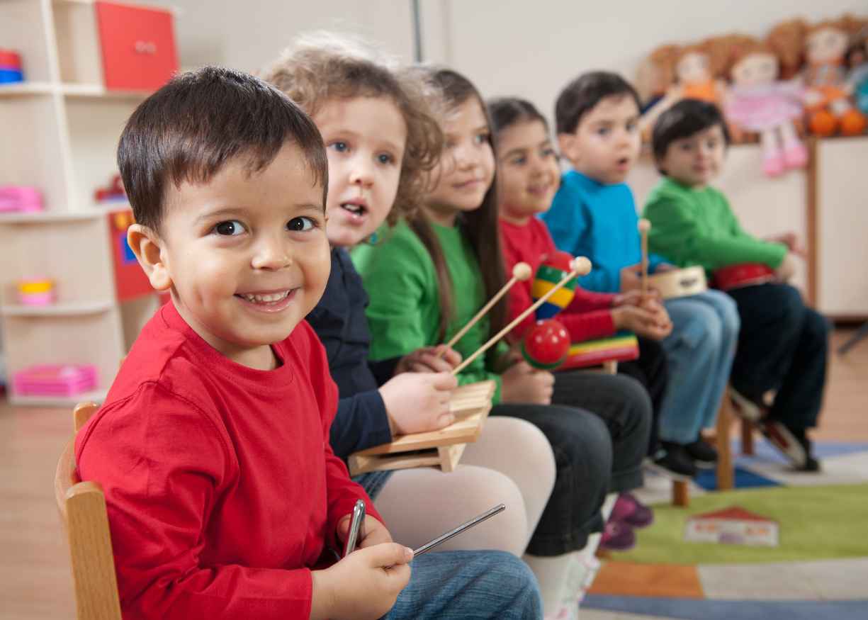 Kinder children making music together in a group