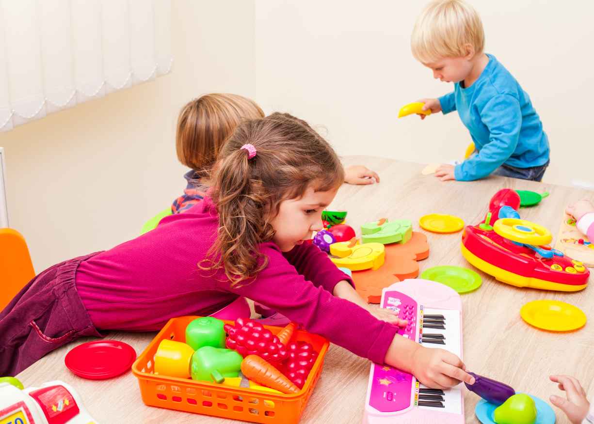 Toddlers pouring, digging and building together