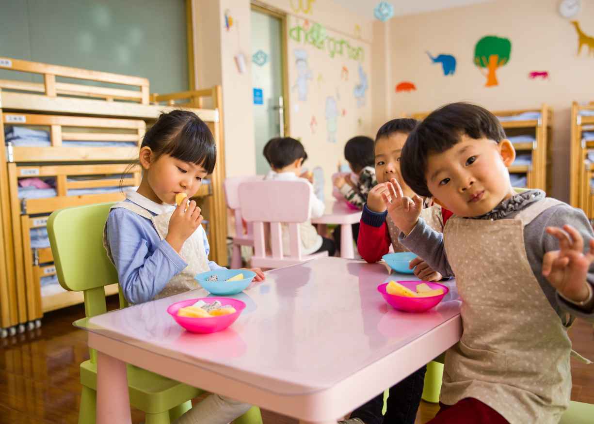 Children eating together at a small table